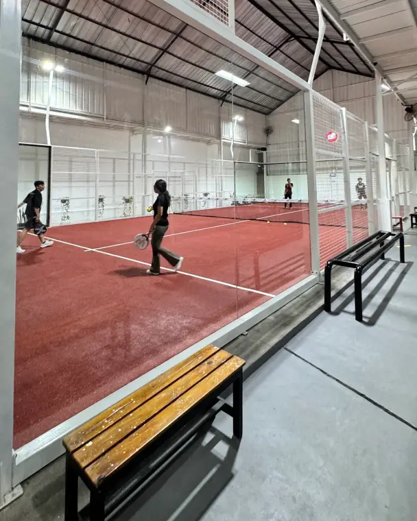 Players rallying on the red court