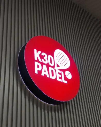 The red K30 Padel lightbox sign
